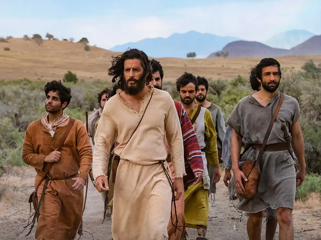 the chosen actors walking down road in period dress